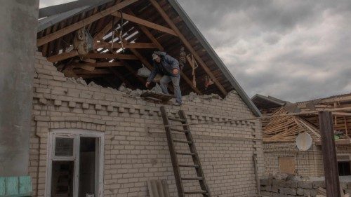 A man clears debris in a damaged house following a recent air attack in a village outside of ... A man clears debris in a damaged house following a recent air attack in a village outside of ...