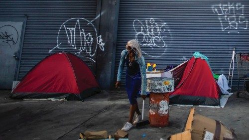 A woman sweepes a sidewalk in an encampment in Skid Row, downtown Los Angeles, California, on July ... A woman sweepes a sidewalk in an encampment in Skid Row, downtown Los Angeles, California, on July ...