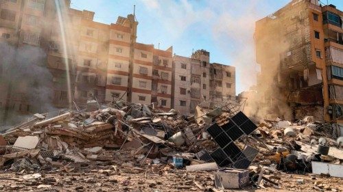 Smoke rises by destroyed buildings from the site of an Israeli air strike the previous day on the ... Smoke rises by destroyed buildings from the site of an Israeli air strike the previous day on the ...