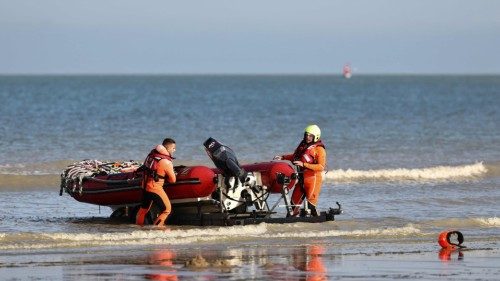 Rescue personnel pull their dinghy out of the water after a rescue operation of migrants attempting ... Rescue personnel pull their dinghy out of the water after a rescue operation of migrants attempting ...