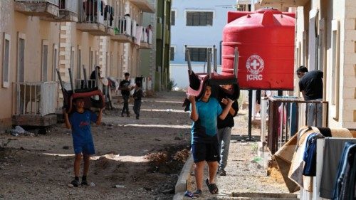 Children walk with chairs outside accommodations housing Lebanese fleeing the war between Israel and ... Children walk with chairs outside accommodations housing Lebanese fleeing the war between Israel and ...