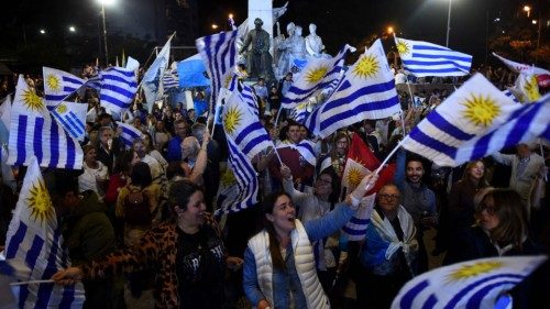 Supporters of the Republican Coalition wave Uruguayan flags after the first results of the ...