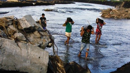 epaselect epa11686950 Villagers cross a river next to a damaged bridge in the aftermath of Tropical ... epaselect epa11686950 Villagers cross a river next to a damaged bridge in the aftermath of Tropical ...
