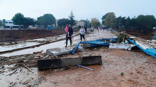 Family members walk in a street covered in mud following floods in Picuana, near Valencia, eastern ... Family members walk in a street covered in mud following floods in Picuana, near Valencia, eastern ...