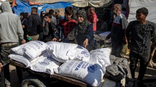 epa11693897 Palestinians receive bags of flour handed out by a United Nations Relief and Works ... epa11693897 Palestinians receive bags of flour handed out by a United Nations Relief and Works ...