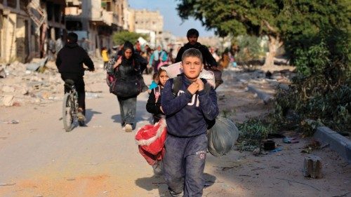Displaced Palestinians fleeing Beit Lahia in the northern Gaza Strip walk on the main Salah al-Din ...