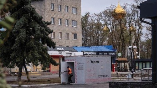 A resident enters a reinforced concrete bomb shelter installed in a street, amid Russia's attack on ...