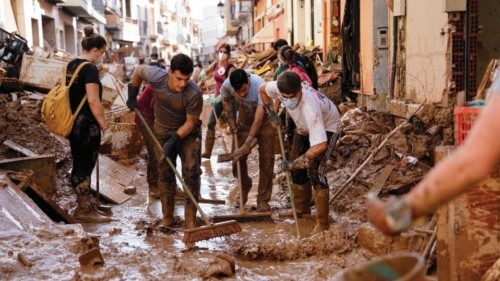 Volunteers and locals help to clean the mud off the street following heavy rains in Paiporta, near ... Volunteers and locals help to clean the mud off the street following heavy rains in Paiporta, near ...