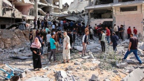 People gather to search for survivors and victims through the rubble following Israeli bombardment ... People gather to search for survivors and victims through the rubble following Israeli bombardment ...