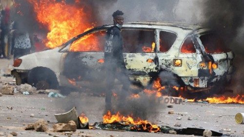 A protester looks on near a burning barricade during a 'national shutdown' against the election ...