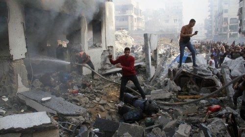 Palestinians inspect the damage at a school sheltering displaced people, after it was hit by an ...