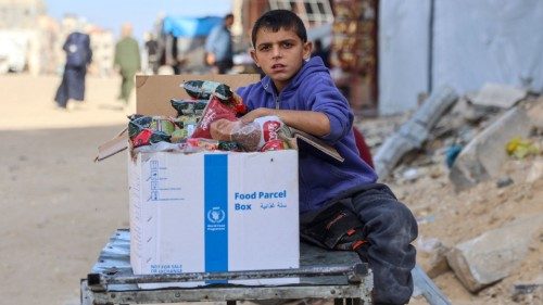 A Palestinian boy sits by a UN World Food Program box of food items, in Gaza City on November 14, ... A Palestinian boy sits by a UN World Food Program box of food items, in Gaza City on November 14, ...