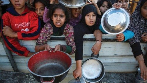 Palestinians gather to receive food cooked by a charity kitchen, amid a hunger crisis, as the ... Palestinians gather to receive food cooked by a charity kitchen, amid a hunger crisis, as the ...