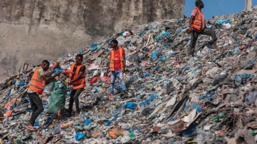 (FILES) A group of cleaners rummages through piles of trash along side of Hamarweyne beach in ...