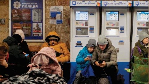 Local residents take shelter in a metro station during an air strike alarm in Kyiv, on November 28, ...