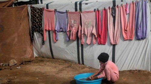 epa11744177 An internally displaced Palestinian girl washes personal belongings outside a makeshift ... epa11744177 An internally displaced Palestinian girl washes personal belongings outside a makeshift ...