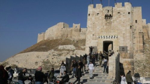 People walk at Aleppo's ancient citadel, after the Syrian army said that dozens of its soldiers had ... People walk at Aleppo's ancient citadel, after the Syrian army said that dozens of its soldiers had ...