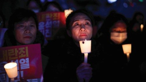 People attend a candlelight vigil condemning South Korean President Yoon Suk Yeol's surprise ...