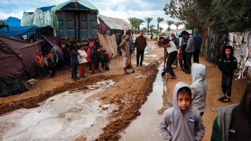 TOPSHOT - People dig channels to ease flooding at a camp for displaced Palestinians in al-Zaywayda ... TOPSHOT - People dig channels to ease flooding at a camp for displaced Palestinians in al-Zaywayda ...