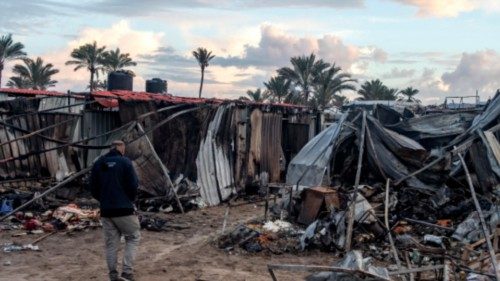 epaselect epa11758055 Internally displaced Palestinians inspect the damage on a tent camp in ... epaselect epa11758055 Internally displaced Palestinians inspect the damage on a tent camp in ...