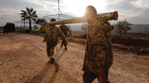 An anti-government fighters carry a rocket to be used against regime forces, in the northern ... An anti-government fighters carry a rocket to be used against regime forces, in the northern ...