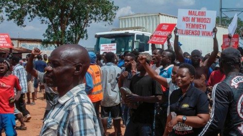Protesters carry placards as they wait to start demonstartions at Lilongwe community ground November ... Protesters carry placards as they wait to start demonstartions at Lilongwe community ground November ...