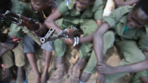 Young boys, children soldiers sit on February 10, 2015 with their rifles at a ceremony of the child ... Young boys, children soldiers sit on February 10, 2015 with their rifles at a ceremony of the child ...