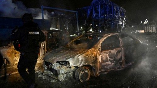 A police officer inspects destroyed cars at the site of a Russian air strike, amid Russia's attack ... A police officer inspects destroyed cars at the site of a Russian air strike, amid Russia's attack ...