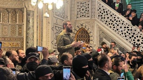 Top rebel commander Abu Mohammed al-Golani speaks to a crowd at Ummayad Mosque in Damascus, after ...