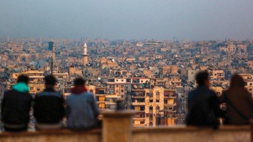 TOPSHOT - Young Syrians sit together at a spot overlooking the northern Syrian city of Aleppo on ... TOPSHOT - Young Syrians sit together at a spot overlooking the northern Syrian city of Aleppo on ...