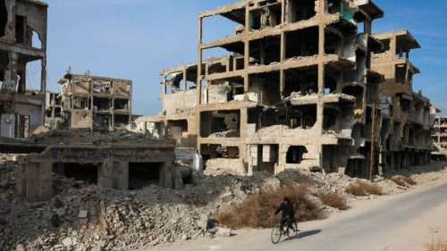 TOPSHOT - A man rides past a destroyed building on a bicycle at the Yarmouk camp for Palestinian ... TOPSHOT - A man rides past a destroyed building on a bicycle at the Yarmouk camp for Palestinian ...