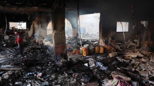Palestinians inspect the damage at the site of an Israeli airstrike on a building in Gaza City's ... Palestinians inspect the damage at the site of an Israeli airstrike on a building in Gaza City's ...
