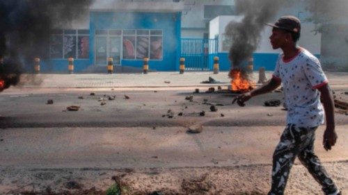 (FILES) A protester walks past burning barricades during a protest in the Choupal neighborhood of ... (FILES) A protester walks past burning barricades during a protest in the Choupal neighborhood of ...