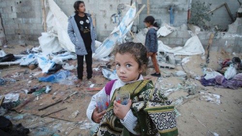 A Palestinian girl holds glasses in her hands as she stands amidst the damage at a tent camp ... A Palestinian girl holds glasses in her hands as she stands amidst the damage at a tent camp ...