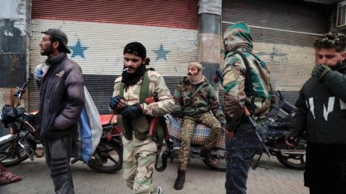 Fighters of the ruling Syrian body secure the area as people gather to celebrate after the ousting ... Fighters of the ruling Syrian body secure the area as people gather to celebrate after the ousting ...