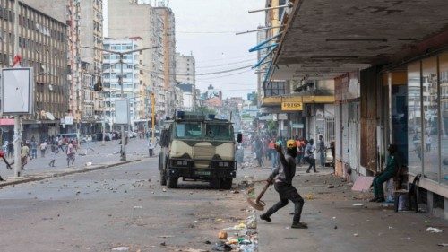 (FILES) A protester throws a stone towards an armoured vehicle as protesters clash with Mozambican ... (FILES) A protester throws a stone towards an armoured vehicle as protesters clash with Mozambican ...