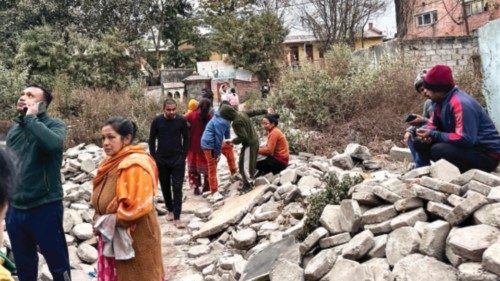 epa11810843 Nepalese people gather after getting out of their homes following an early morning ...