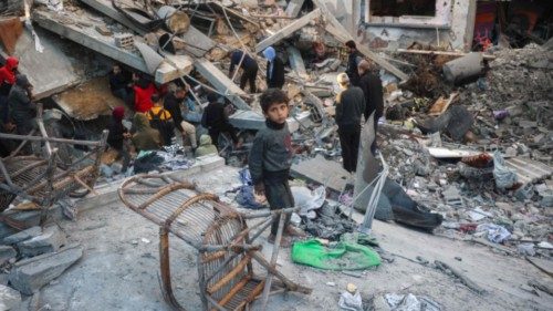People search the rubble of a building destroyed in an Israeli strike on the Bureij camp for ... People search the rubble of a building destroyed in an Israeli strike on the Bureij camp for ...