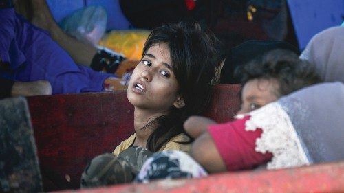 Children are seen on a boat holding Rohingya refugees as it anchors off the coast of Labuhan Haji in ... Children are seen on a boat holding Rohingya refugees as it anchors off the coast of Labuhan Haji in ...