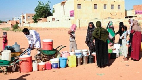People queue for water in Omdurman, the Sudanese capital's twin city, during battles between the ...