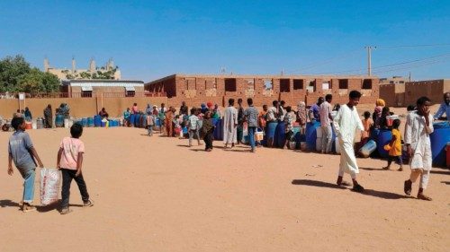 People queue for water in Omdurman, the Sudanese capital's twin city, during battles between the ...
