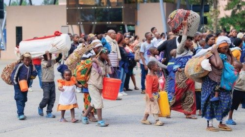 epa11856283 Refugees carry their belongings after crossing the border from Goma in the Democratic ...