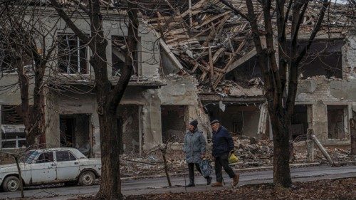 Residents walk past a building damaged by Russian military strikes, amid Russia's attack on Ukraine, ... Residents walk past a building damaged by Russian military strikes, amid Russia's attack on Ukraine, ...
