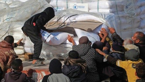 TOPSHOT - People gather to collect humanitarian aid after trucks arrived in the Gaza Strip via the ... TOPSHOT - People gather to collect humanitarian aid after trucks arrived in the Gaza Strip via the ...