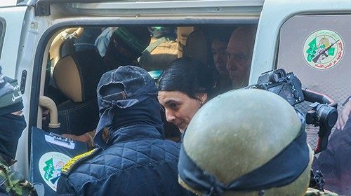 TOPSHOT - Palestinian militant group Islamic Jihad and Hamas fighters escort Israeli hostages Arbel ... TOPSHOT - Palestinian militant group Islamic Jihad and Hamas fighters escort Israeli hostages Arbel ...