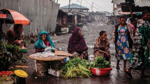 Sellers react while waiting for customers at a roadside market as residents gradually return to the ...