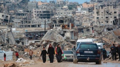 TOPSHOT - Displaced Palestinians walk through a muddy road amid the destruction in Jabalia in the ... TOPSHOT - Displaced Palestinians walk through a muddy road amid the destruction in Jabalia in the ...