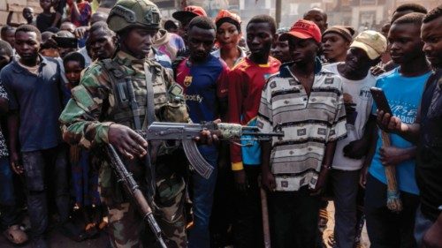 TOPSHOT - A member of the M23 movement inspects weapons recovered by residents during street ... TOPSHOT - A member of the M23 movement inspects weapons recovered by residents during street ...