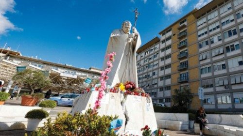 People pray in front of the statue of John Paul II at the entrance to the Gemelli Hospital, where ... People pray in front of the statue of John Paul II at the entrance to the Gemelli Hospital, where ...