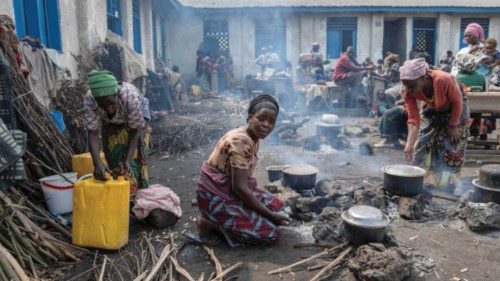 Anociata Nyiranzarura, 45, prepares food for her internally displaced Congolese family in a ... Anociata Nyiranzarura, 45, prepares food for her internally displaced Congolese family in a ...